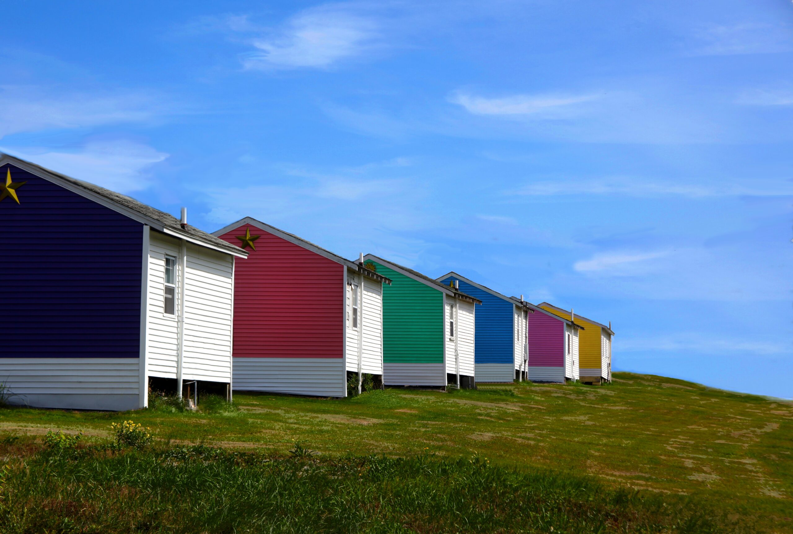 A breathtaking shot of colorful houses on a blue sky background