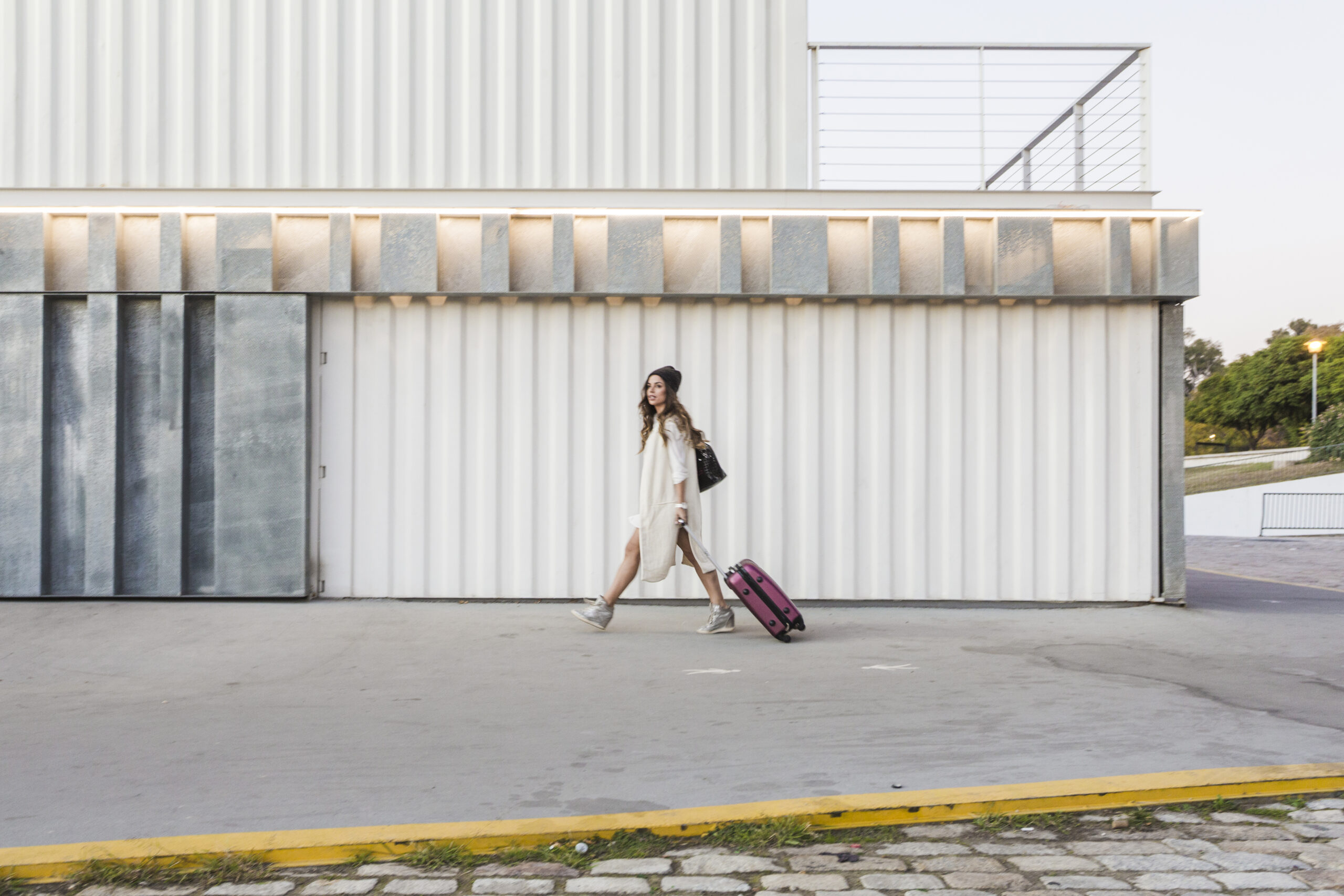 woman-with-suitcase-walking-street